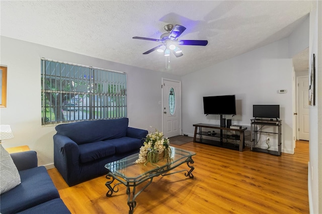 4318 Mesa Dr, New Port Richey, FL 34653 - living area with wood finished floors, a ceiling fan, vaulted ceiling, and a textured ceiling