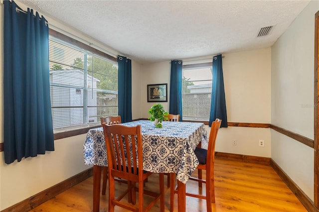 4318 Mesa Dr, New Port Richey, FL 34653 - dining room with wood finished floors and a textured ceiling