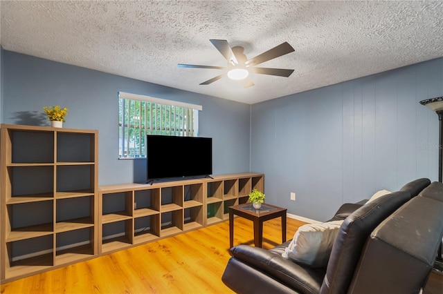 4318 Mesa Dr, New Port Richey, FL 34653 - living room with a ceiling fan, a textured ceiling, and wood finished floors