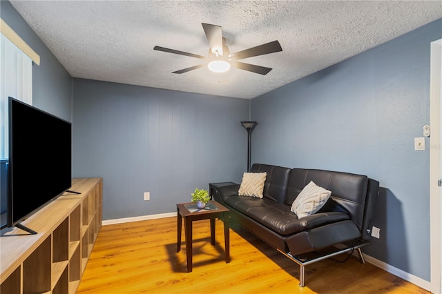 4318 Mesa Dr, New Port Richey, FL 34653 - living area featuring wood finished floors, ceiling fan, and a textured ceiling