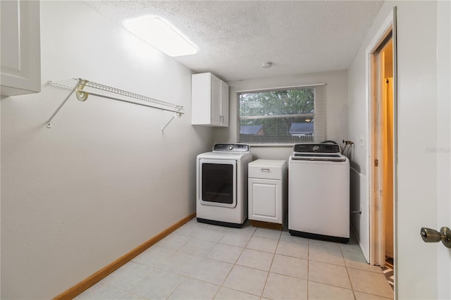 4318 Mesa Dr, New Port Richey, FL 34653 - laundry room featuring cabinet space, a textured ceiling, independent washer and dryer, and light tile patterned floors