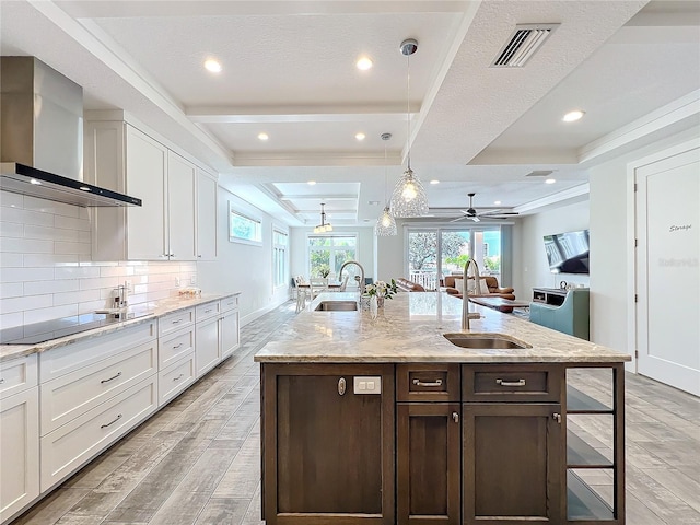 1204 Derby Ln, Sarasota, FL 34242 - kitchen featuring wall chimney range hood, a sink, light wood-style flooring, and recessed lighting