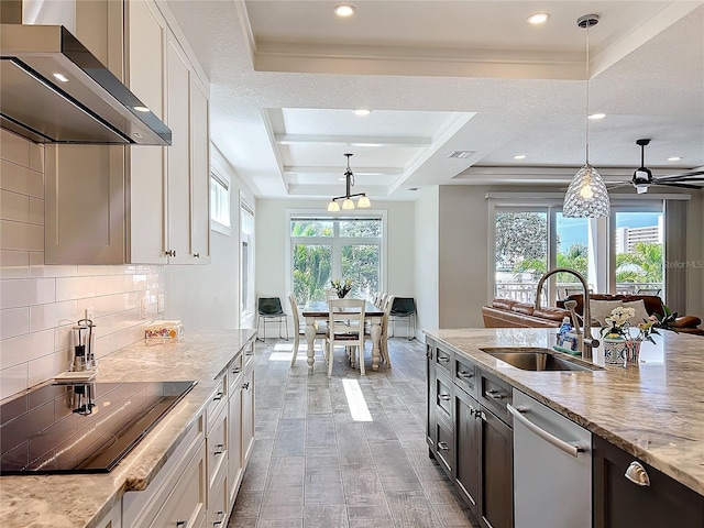 1204 Derby Ln, Sarasota, FL 34242 - kitchen featuring a sink, wall chimney exhaust hood, black electric stovetop, stainless steel dishwasher, and a raised ceiling