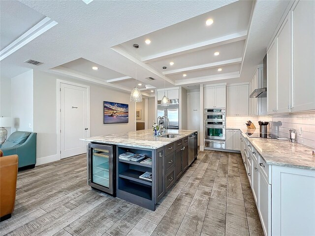 1204 Derby Ln, Sarasota, FL 34242 - kitchen with beverage cooler, a sink, light wood-style flooring, backsplash, and recessed lighting