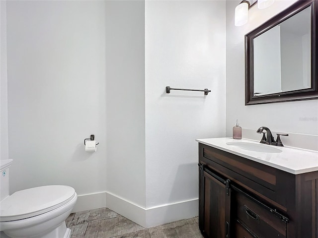 1204 Derby Ln, Sarasota, FL 34242 - half bathroom featuring vanity, toilet, and baseboards
