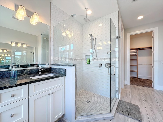 1204 Derby Ln, Sarasota, FL 34242 - full bathroom featuring a stall shower, a walk in closet, and vanity