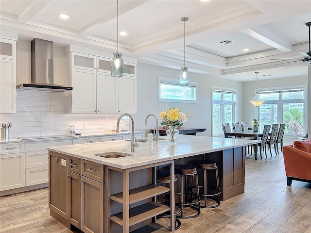 1204 Derby Ln, Sarasota, FL 34242 - kitchen with wall chimney range hood, a sink, coffered ceiling, light wood-style flooring, and decorative backsplash
