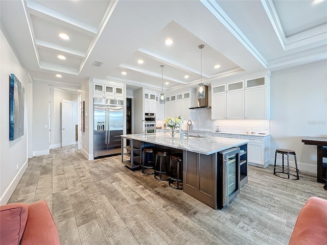 1204 Derby Ln, Sarasota, FL 34242 - kitchen featuring appliances with stainless steel finishes, wine cooler, a kitchen breakfast bar, a large island, and decorative backsplash