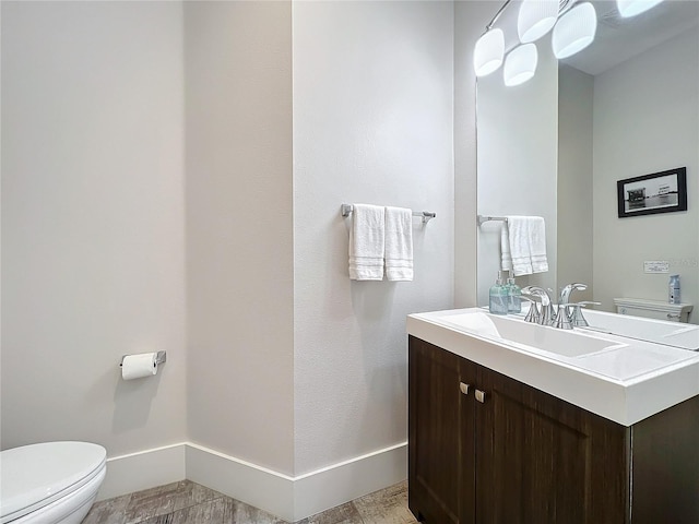1204 Derby Ln, Sarasota, FL 34242 - bathroom with toilet, vanity, and baseboards