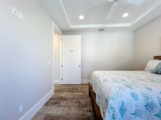 1204 Derby Ln, Sarasota, FL 34242 - bedroom featuring dark wood-style flooring, a raised ceiling, baseboards, ceiling fan, and recessed lighting
