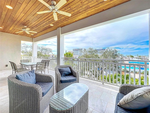 1204 Derby Ln, Sarasota, FL 34242 - balcony featuring ceiling fan and outdoor dining area