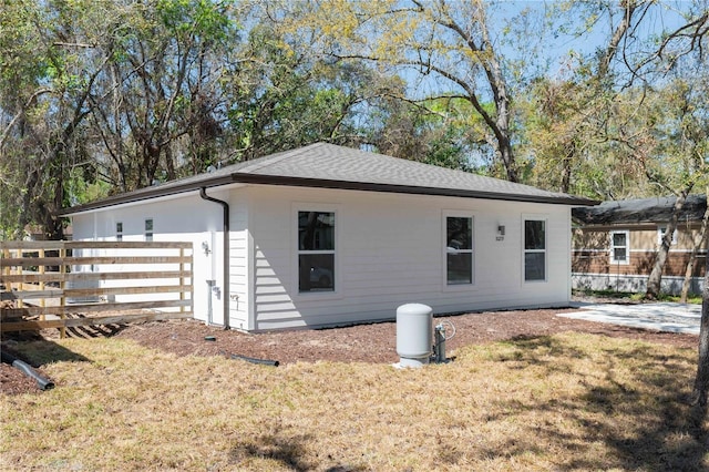 10219 Huntley St, New Port Richey, FL 34654 - view of side of home with roof with shingles
