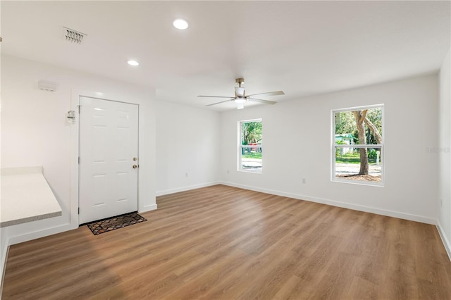 10219 Huntley St, New Port Richey, FL 34654 - empty room featuring ceiling fan, light wood-style flooring, plenty of natural light, and recessed lighting
