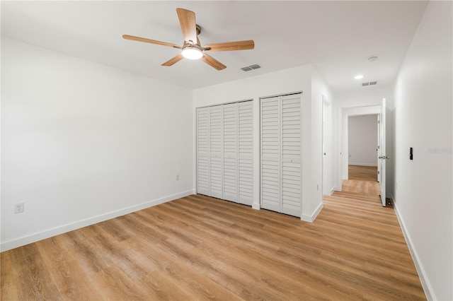 10219 Huntley St, New Port Richey, FL 34654 - unfurnished bedroom featuring multiple closets, light wood-style flooring, recessed lighting, and ceiling fan