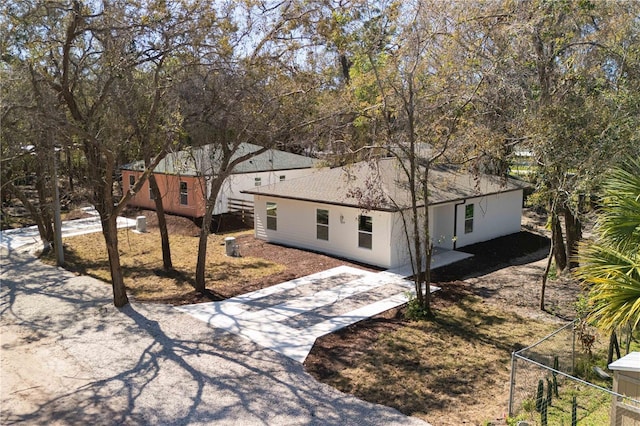 10219 Huntley St, New Port Richey, FL 34654 - view of front of house with stucco siding, driveway, and a shingled roof