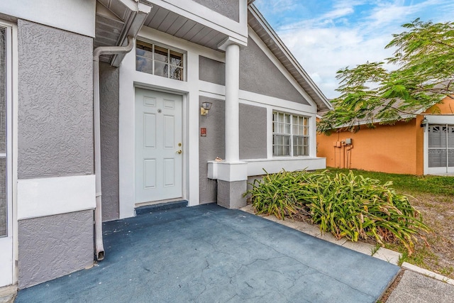 921 Linn Harbor Ct, Tarpon Springs, FL 34689 - property entrance featuring stucco siding