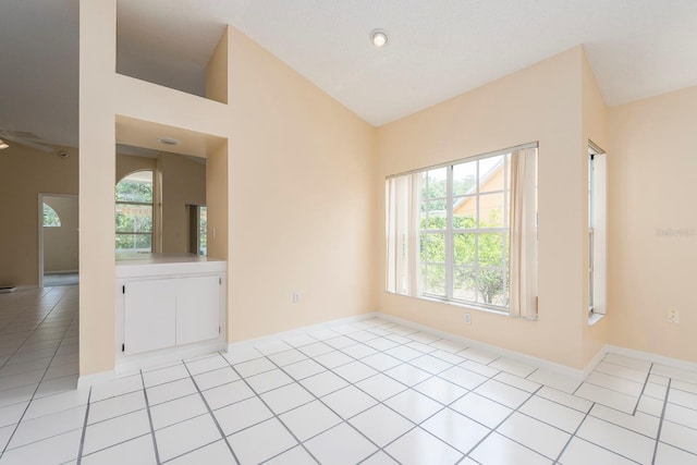 921 Linn Harbor Ct, Tarpon Springs, FL 34689 - unfurnished room featuring light tile patterned floors, baseboards, and vaulted ceiling