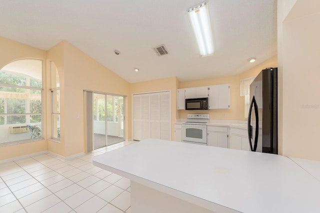 921 Linn Harbor Ct, Tarpon Springs, FL 34689 - kitchen with black microwave, white electric range oven, freestanding refrigerator, white cabinetry, and light countertops