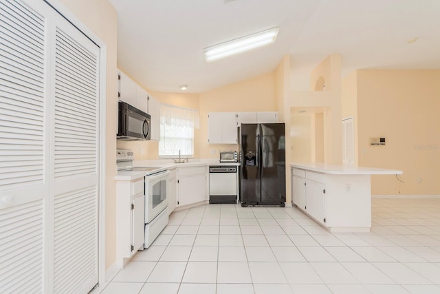 921 Linn Harbor Ct, Tarpon Springs, FL 34689 - kitchen featuring black appliances, light countertops, vaulted ceiling, a peninsula, and white cabinets