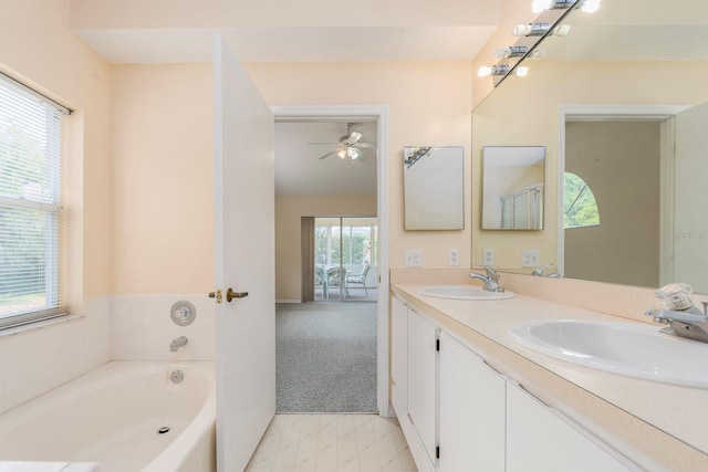 921 Linn Harbor Ct, Tarpon Springs, FL 34689 - full bathroom with double vanity, a bath, and ceiling fan