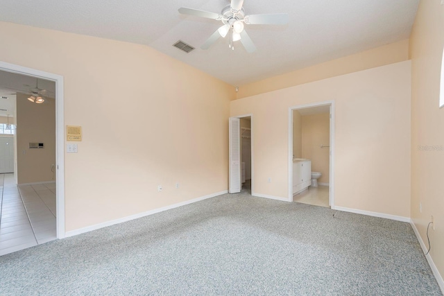 921 Linn Harbor Ct, Tarpon Springs, FL 34689 - unfurnished bedroom with light colored carpet, lofted ceiling, baseboards, ensuite bath, and ceiling fan