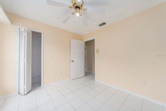 921 Linn Harbor Ct, Tarpon Springs, FL 34689 - unfurnished bedroom with baseboards, a closet, a ceiling fan, and light tile patterned flooring