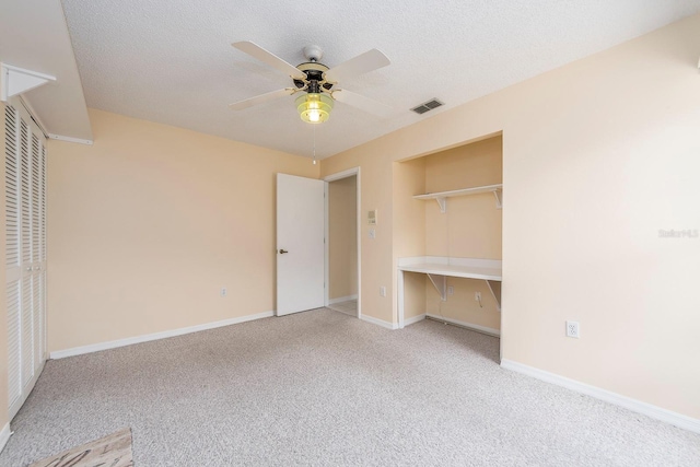 921 Linn Harbor Ct, Tarpon Springs, FL 34689 - unfurnished bedroom with carpet floors, a closet, baseboards, and a textured ceiling