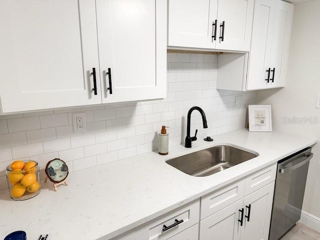3640 41st Ln S Unit F, Saint Petersburg, FL 33711 - kitchen featuring stainless steel dishwasher, white cabinets, decorative backsplash, and light stone counters