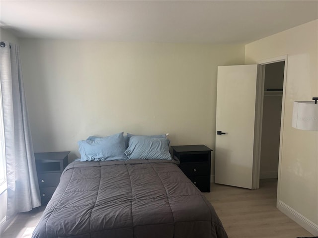 3640 41st Ln S Unit F, Saint Petersburg, FL 33711 - bedroom with light wood finished floors and baseboards
