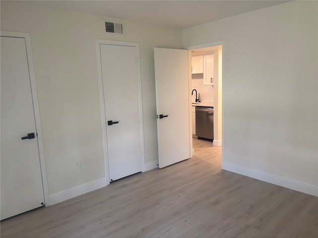 3640 41st Ln S Unit F, Saint Petersburg, FL 33711 - unfurnished bedroom featuring light wood-style floors and baseboards