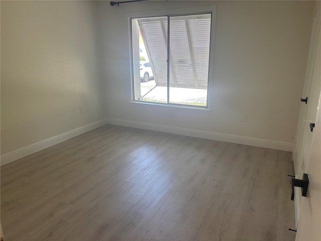 3640 41st Ln S Unit F, Saint Petersburg, FL 33711 - unfurnished room featuring wood finished floors and baseboards