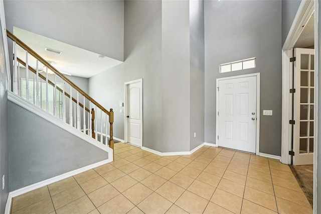 7509 Tangle Bend Dr, Gibsonton, FL 33534 - entrance foyer with a towering ceiling, light tile patterned floors, stairway, and healthy amount of natural light