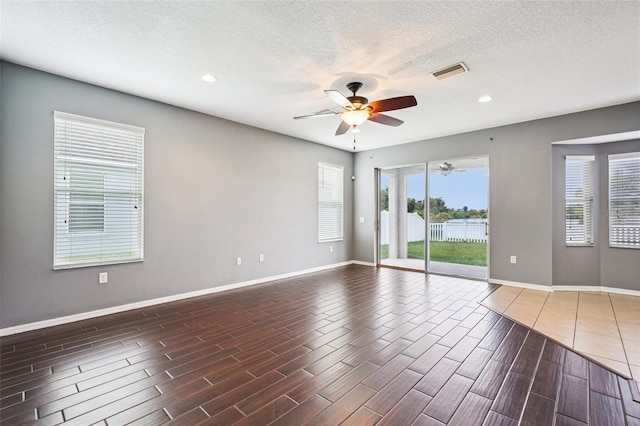 7509 Tangle Bend Dr, Gibsonton, FL 33534 - empty room with a ceiling fan, wood tiled floors, a textured ceiling, and recessed lighting