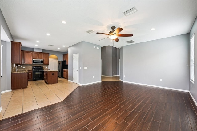 7509 Tangle Bend Dr, Gibsonton, FL 33534 - unfurnished living room with ceiling fan, light wood finished floors, arched walkways, and recessed lighting