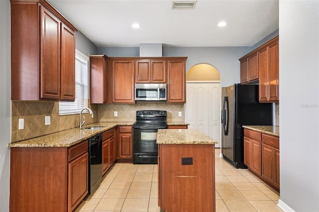 7509 Tangle Bend Dr, Gibsonton, FL 33534 - kitchen with black appliances, a center island, backsplash, light stone countertops, and recessed lighting
