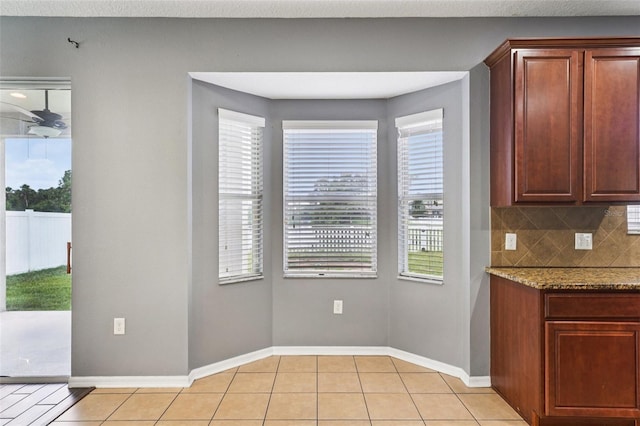 7509 Tangle Bend Dr, Gibsonton, FL 33534 - kitchen featuring light tile patterned floors, stone countertops, and tasteful backsplash