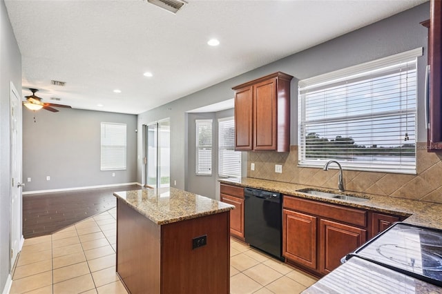 7509 Tangle Bend Dr, Gibsonton, FL 33534 - kitchen featuring black appliances, a center island, light tile patterned floors, a ceiling fan, and tasteful backsplash