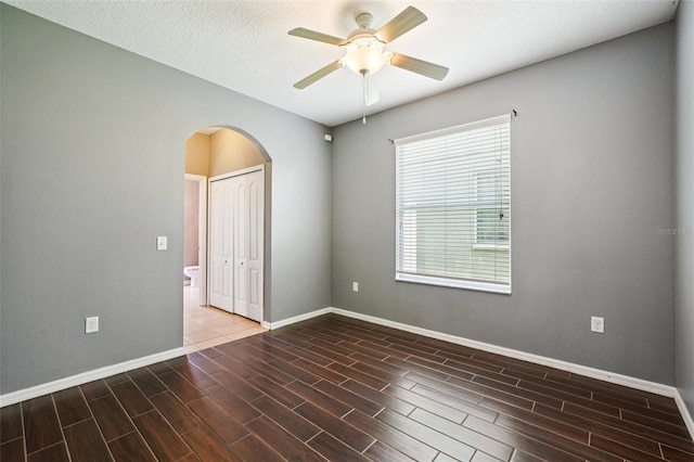 7509 Tangle Bend Dr, Gibsonton, FL 33534 - spare room with arched walkways, wood tiled floors, and ceiling fan