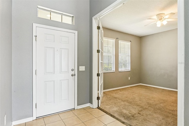 7509 Tangle Bend Dr, Gibsonton, FL 33534 - entryway featuring a ceiling fan, light carpet, and light tile patterned floors