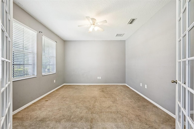 7509 Tangle Bend Dr, Gibsonton, FL 33534 - carpeted empty room featuring french doors, a ceiling fan, and a textured ceiling