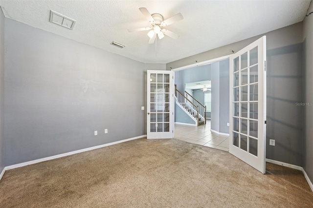 7509 Tangle Bend Dr, Gibsonton, FL 33534 - tiled spare room with french doors, ceiling fan, and carpet