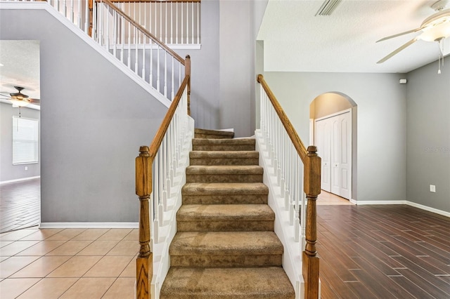 7509 Tangle Bend Dr, Gibsonton, FL 33534 - staircase with ceiling fan, arched walkways, wood finished floors, and a textured ceiling