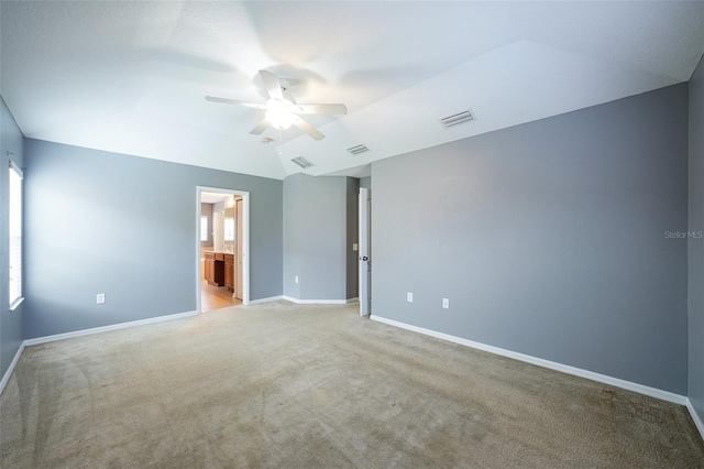 7509 Tangle Bend Dr, Gibsonton, FL 33534 - unfurnished bedroom featuring carpet, ceiling fan, lofted ceiling, and ensuite bathroom