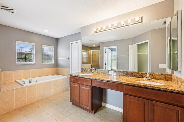 7509 Tangle Bend Dr, Gibsonton, FL 33534 - bathroom with a shower stall, tile patterned flooring, double vanity, a bath, and healthy amount of natural light