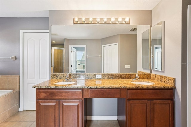 7509 Tangle Bend Dr, Gibsonton, FL 33534 - bathroom featuring tile patterned flooring, double vanity, a stall shower, and a bath