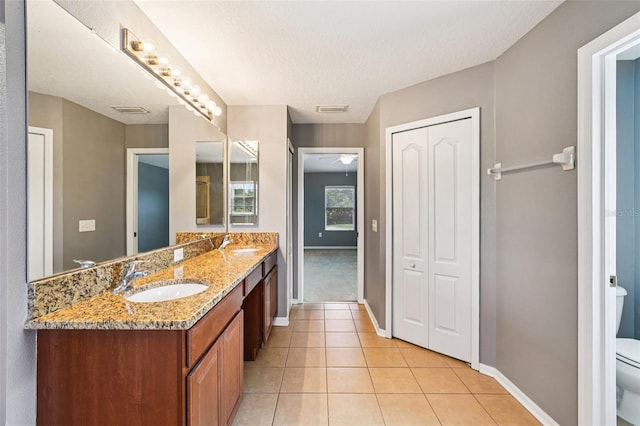 7509 Tangle Bend Dr, Gibsonton, FL 33534 - full bath with double vanity, tile patterned floors, and a textured ceiling