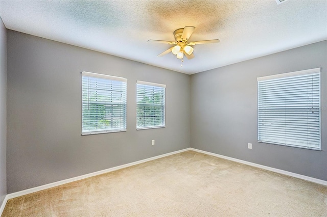 7509 Tangle Bend Dr, Gibsonton, FL 33534 - unfurnished room with light colored carpet, ceiling fan, and a textured ceiling
