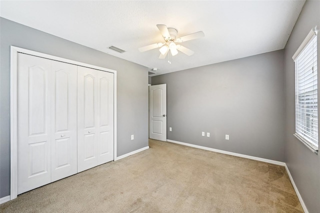 7509 Tangle Bend Dr, Gibsonton, FL 33534 - unfurnished bedroom with carpet, a closet, and a ceiling fan