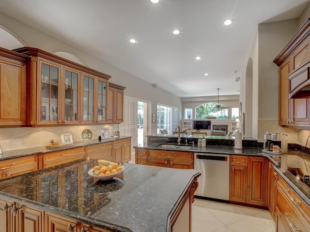 4335 Clairidge Way, Palm Harbor, FL 34685 - kitchen with stainless steel dishwasher, arched walkways, recessed lighting, brown cabinetry, and glass insert cabinets