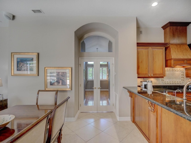 4335 Clairidge Way, Palm Harbor, FL 34685 - kitchen featuring light tile patterned floors, french doors, dark stone counters, recessed lighting, and tasteful backsplash
